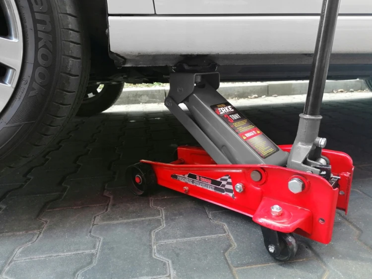 Podnośnik hydrauliczny samochodowy typu żaba 3 t 3000 kg - widok na podnośnik podnoszący samochód.